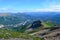 View of Nenana river valley from Mount Healy hike trail with blue sky with white clouds above. Denali National Park