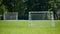 View of a net on vacant soccer pitch.