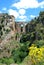 View of the New Bridge and ravine with pretty Spring flowers, Ronda, Spain.