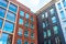 View of a new residential rectangular modern inside corner red and black brick house with classic windows