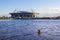 View of new stadium `Zenith Arena` from Neva River with floating construction helmet, St. Petersburg, Russia