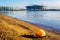 View of new stadium `Zenith Arena` from opposite shore of sandy beach with floating construction helmet, St. Petersburg, Russia