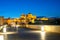 View at night across Roman bridge on Guadalquivir river of Great Mosque in Cordoba. Andalusia, Spain