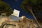 View of the night historical Buildings and the crown of a huge tree. unusual perspective. Night Rome Europe.