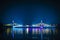 View of night scenery of city in Thailand  with beautiful reflections of skyscrapers and bridges by riverside in twilight.