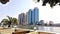 A view of the Nile Corniche in Cairo, showing the towers of the National Bank of Egypt and the Nile City towers with daylight