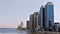 A view of the Nile Corniche in Cairo, showing the towers of the National Bank of Egypt and the Nile City towers with the reflectio