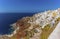 A view of the northern edge of the village of Oia, Santorini with Amoudi Bay at the base of the cliffs