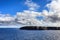 View at Noss Head Lighthouse from sea with blue skye and white clouds