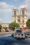 View of the Notre Dame de Paris on the island Cite in Paris against the background of the sign on the roof of a taxi Taxi Parisien