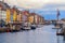 View of Nyhavn pier with color buildings and ships in Copenhagen, Denmark