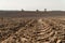 View oÐ° a ploughed fields with a tractor tire track.