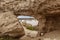 View of the oasis of the Namibe Desert, through the arch. Angola. Africa