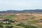 A view from observation deck to fields, farms and mountains near Consuegra town at spring cloudy day, Castilla La Mancha