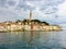 A view from the ocean facing the old town of Rovinj, Croatia.  Old colourful buildings and the clock tower dominate the skyline