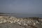 A view of the ocean seen over a foreground of rocks and gravel