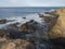 View of ocean waves and the cllifs at rocky sea shore at wild Vicentina coast in Porto Covo, Portugal. Rota Vicentina