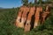 View of ocher land cliffs under a sunny blue sky, in a park near Roussillon.