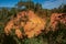 View of ocher land and people in the park `Sentiers des Ocres` under a sunny blue sky, near Roussillon.