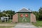 View of an old boathouse with the Danish flags and a boat next to it