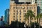 View of the old building in the CBD with modern skyscrapers behind it and palm trees in the foreground in Brisbane Queensland Aust