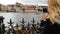 View of the old city of Prague and the Vltava River, and Boats pass on,a girl standing on the bridge with a lot of iron