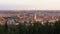 View of old city with river in middle, towers rising up over rooftops, panorama