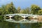 View on old classic bridge in center island with joyful happy  people walking toward the beach on sunny  day