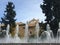 View of an old convent through rows of water fountains