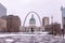 View of an old courthouse with Gateway Arch behind on a snow winter day
