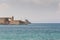 View at old fortification in old port from Akti Sachtouri sea promenade with Delphinia, sculpture of Dolphins. Rhodes, Old Town,
