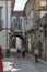 View at a old and narrow street with classic buildings on downtown Guimaraes city, tourist people strolling