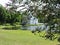 View of old pavillion, lake in blooming park, Saint-Petersburg