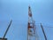 View of an old red and white telecommunication tower looking up from ground level