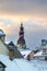 View on Old Riga roofs and Saint Peters Church tower on sunset.