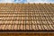 View of old roof textures against blue sky.