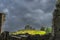 View through old ruins of Hore Abbey walls on Rock of Cashel castle with dark dramatic storm sky