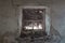 View from old scary window with a web on the street in the dark. Window view of an abandoned old house, building, barn