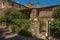 View of old stone house with stone fence and flowers at Les Arcs-sur-Argens.