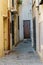 View of old street in Dalt la Vila, building with colored facade, historic center of Badalona, province of Barcelona, Spain