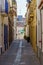 View of old street in Dalt la Vila, building with colored facade, historic center of Badalona, province of Barcelona, Spain