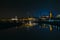 View of the old town of Dresden at night with a view of water and the reflection of the city as well as, churches, towers and bui