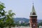 View of the old town and the hill, chapel or tower with clock and spire. green, but built-up modern city