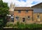 View of old waterside buildings by Hen Brook  St Neots with St Marys  Church Tower in background.