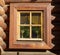 View of an old window in a wall of softwood logs on a clear sunny day. Architecture, elements, style