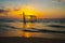 The view of the old wooden bridge decayed in the middle of the ocean in the evening.