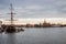 View of old wooden ship moored to river Niva embankment with Piters and Paul cathidral on the background in St. Petersburg