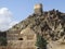 View of oldest mosque and a Portuguese Fort watch tower on hilltop in Fujairah, United Arab Emirates