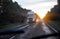 View from an oncoming car on a wet slippery road in the rain. Trucks with headlights on a sunset background. Aquaplaning on the