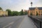 View on one of central streets in Uppsala, Sweden, Europe. Small bridge over river , yellow buildings, red castle far away.